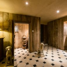 Rustic Space With Wood Paneling and Dog Statues