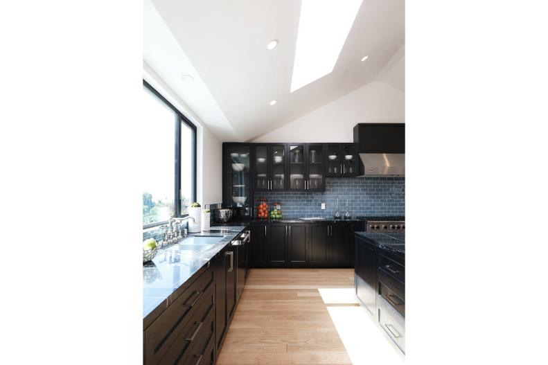 Black Cabinets and Marble Counters in Spacious Modern Chef's Kitchen