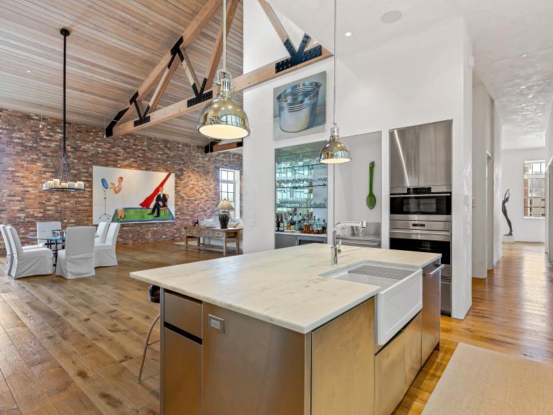 Open Concept Space With Kitchen Island and Exposed Wood Beams