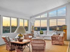 Sunroom Features Large Windows and Vaulted Ceilings