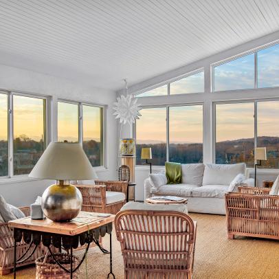Sunroom With Vaulted Ceilings Features Large Windows and Lounge Furniture 