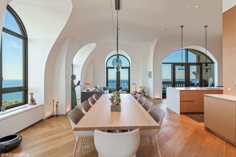 Living Space With Large Dining Table and Arched Windows