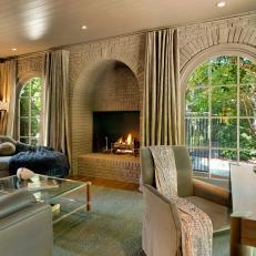 Brown Transitional Living Room With Arched Fireplace