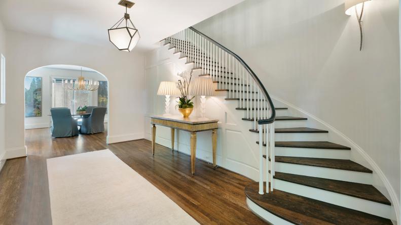 White Foyer With Curved Stairs