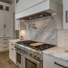 White Chef Kitchen With Marble Countertops