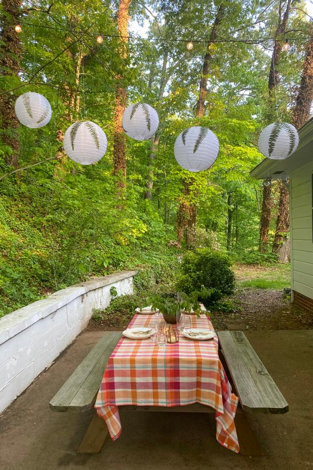 Five Botanical Paper Lanterns Hang in Patio Above Outdoor Table