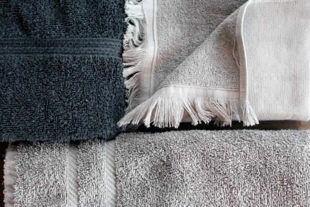 Close-up of two gray towels and one black towel