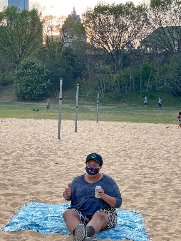 Since HGTV.com editor Jessica Yonker couldn't get to the beach just yet, she tested a Sand Cloud XL beach towel's sand-resistance in her local park at a volleyball court.