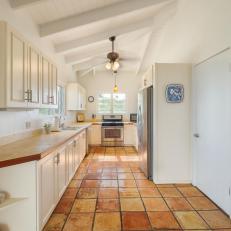 Galley Kitchen With Terra Cotta Tile