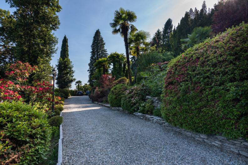 Hedges Line Long Gravel Driveway That Leads to Villa Property