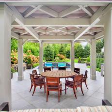 Outdoor Dining Room With White Pergola