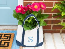Canvas totes are not only handy for weekend trips and shopping outings; when monogrammed, they also make sweet gifts and even a perfectly personalized planter for your front porch.