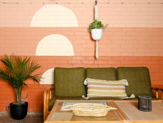 Orange Ombre Walls in Sunroom with Tiki Inspired Decor, Green Sofa