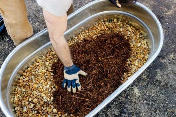 Putting Mulch Into The Galvanized Tub