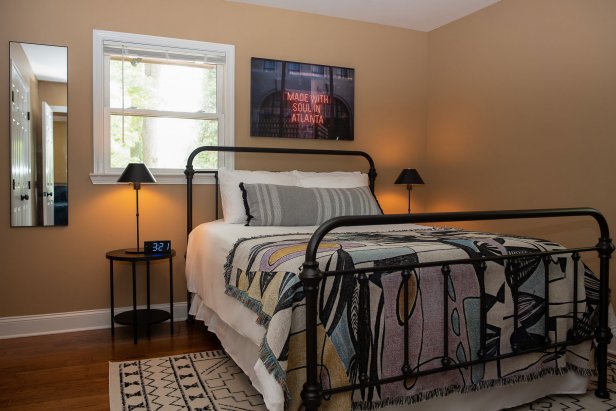 Modern Bedroom with Black Accent Colors, Lamps, Mirror, Rug, Poster 