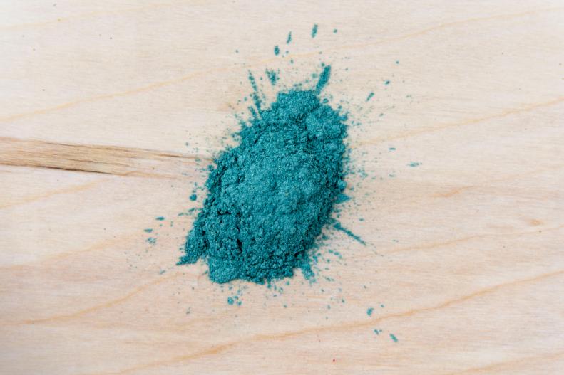 Blue Synthetic Mica Piled Up On Wooden Work Table