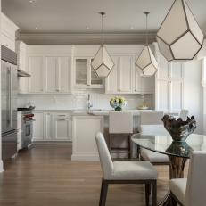 White Kitchen and Dining Area With Diamond Pendants