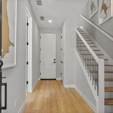 Transitional Front Entryway With Sleek Gray and Wooden Stairway