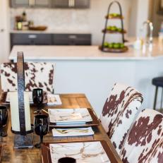 Rustic Wooden Dining Table With Cow Hide Print Dining Chairs