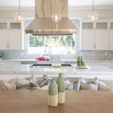 Pristine White Kitchen With Gleaming Stainless Steel Range Hood