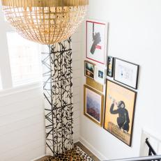 Eclectic Stair Landing With Globe Chandelier, Animal Print Carpet and Gallery Wall 