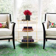 Contemporary Sitting Area With Brass Table, Black and White Armchairs and Green Vintage Area Rug 