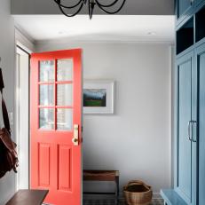 Foyer Features Patterned Tile and a Vibrant Red Door