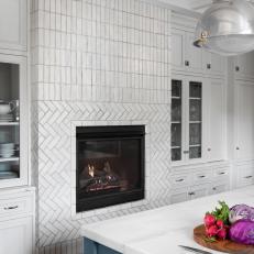 Kitchen Fireplace Features White Tile Laid in Two Intricate Patterns