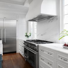 Traditional Kitchen With White Cabinets and Marble Countertops