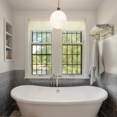 Bathroom Nook Features a Freestanding Tub and Large Windows