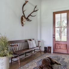 Rustic Farmhouse-Style Foyer With Iron Pendant, Vintage Area Rug and Antique Bench