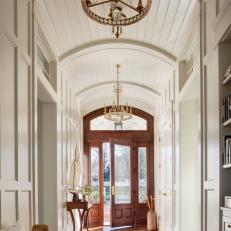 Traditional White Hallway With Barrel Ceiling, Crystal Chandeliers and Inlaid Compass Rose 