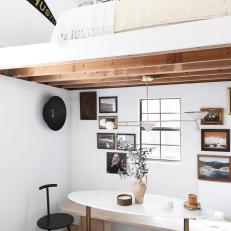 White Contemporary Dining Nook With Gallery Wall and Lofted Bed 