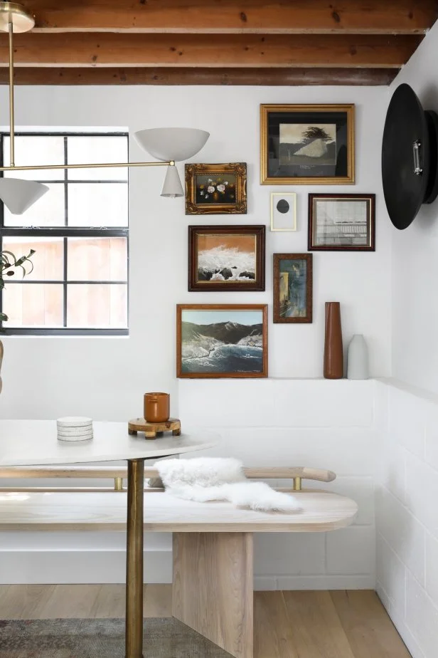 Black and white dining nook with natural beamed ceiling.