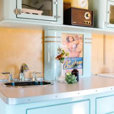Kitchen Nook With Blue Cabinets and Retro Appliances