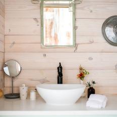 Rustic Bathroom With Wood Paneling and a Vessel Sink