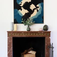 Red Marble Fireplace and Blue Art