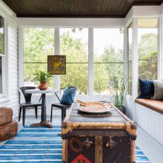 Bright Sunroom Feature Antique Furniture and a Blue Rug