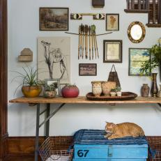 Eclectic Artwork Hangs Above an Antique Console Table