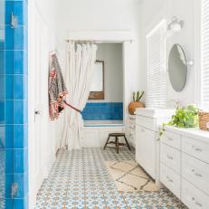 Vibrant Bathroom Features Blue Tile and a Traditional Vanity 