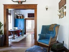 Living Space With a Blue Armchair and Cowhide Rug