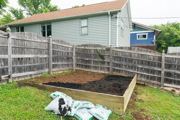 Before you begin, ensure the backyard area where the stock tank pool will live is perfectly level. If your yard is not level, build a raised bed following these steps. Stake out the dimensions with a string and rebar. Then, dig small trenches along three sides of the uneven side or slope. Measure the wood to fit the trenches and dig holes for posts. Mix concrete, set posts and let set for one hour. Last, screw the boards to posts, fill the area with dirt and tamp to level. Check accuracy with a level.