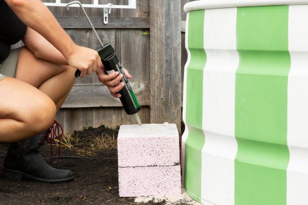 Paint standard cinderblocks a colorful pink using a roller. Then adhere them together with caulking to create a stylish, step entry point to the pool.