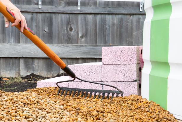 Pour loose gravel around the pool to create a deck. Level the gravel with a rake.