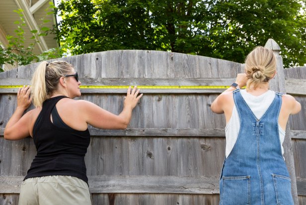 Make an outdoor trellis for pool accessories. Start by measuring the trellis to determine spacing for drilled holes in the fence. Then, paint the trellis white and let dry for several hours. Add hangers to the fence, place the trellis and enjoy.