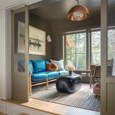 Contemporary Cabin Sitting Room With Copper Pendant and Khaki Walls 