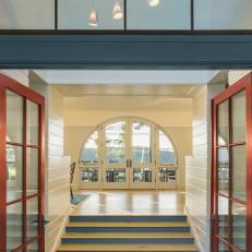 Grand Contemporary Cabin Entryway With Red Doors and Arched Glass 