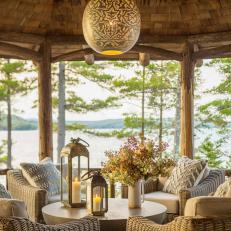 Lakefront Gazebo With Intricate Globe Pendant, Wooden Shingles and Woven Armchairs 