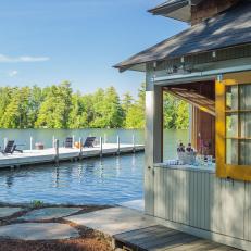 Green Lakefront Boathouse With Private Dock and Seating Area 
