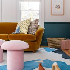 Contemporary Style Living Room With Funky Pink Ottomans and Bold Patterned Rug
